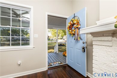 Entrance foyer with dark wood-style flooring, plenty of natural light, and ceiling fan