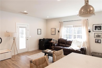Living area featuring light wood-style flooring, recessed lighting, and baseboards