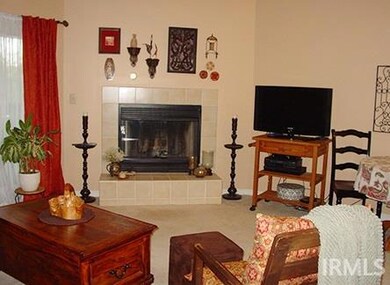 Living room has vaulted ceiling and fireplace with access to screened in back porch.