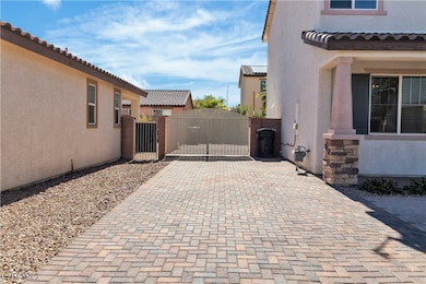 View of side of home with a gate, stucco siding, d