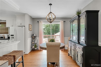 Dining area featuring a chandelier, wainscoting, a