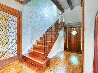 Beauty and elegance are reflected in this spot of the home, a featured double leaded, beveled glass door and magnificent staircase leading to the second floor.  This area of the home has a powder room and coat closet also is the entrance to the lower