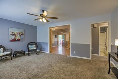 Open floor plan with living room, kitchen, and sli