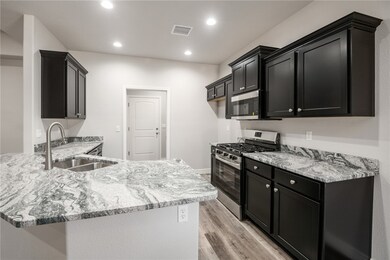 Kitchen featuring stainless steel appliances, a si