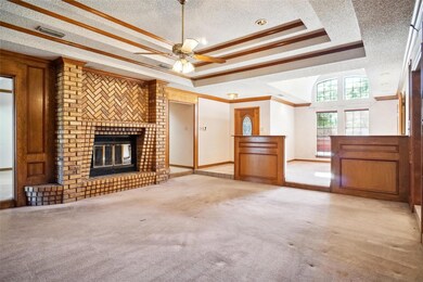 Living Area with a textured ceiling, a tray ceilin