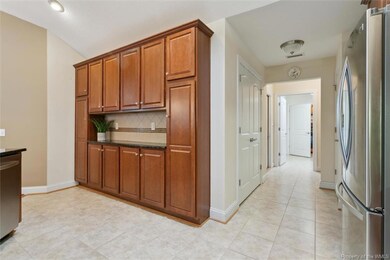 Extra wall of cabinets and pantry down the hallway