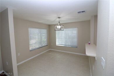 Empty room with light tile patterned floors and an