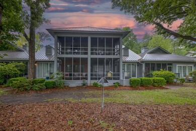 Back of house at dusk featuring a standing seam ro
