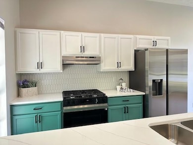 Kitchen featuring stainless steel fridge with ice 