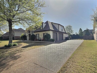 View of property exterior featuring a garage, a ya