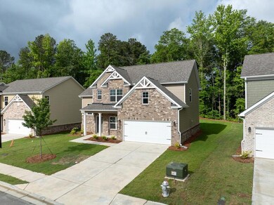 Craftsman house with a shingled roof, a porch, a front lawn, and concrete driveway