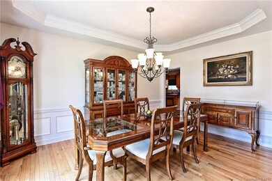 Dining room with tray ceiling, decorative molding.