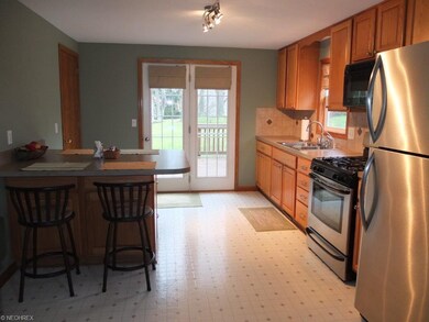 Applianced kitchen with ceramic tile backsplash, o