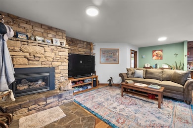 Living area featuring a stone fireplace