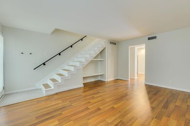 Unfurnished living room with stairs, baseboards, 
