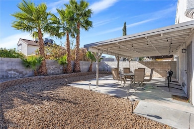 Rear yard with covered patio and lush landscaping