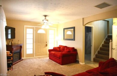 Spacious living room offers wall to wall carpet, c