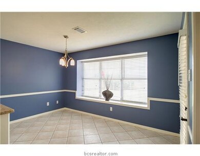 Dining Room. The breakfast room is open to the kitchen and living room and overlooks the backyard.