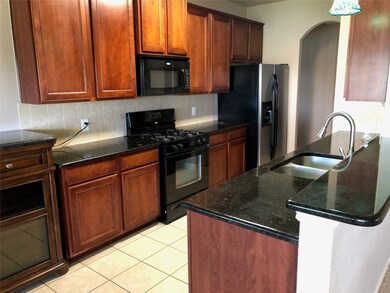 Kitchen features 42 inch cabinets, granite counters, gas cooking and pantry.