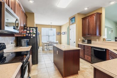Kitchen featuring black appliances, decorative bac