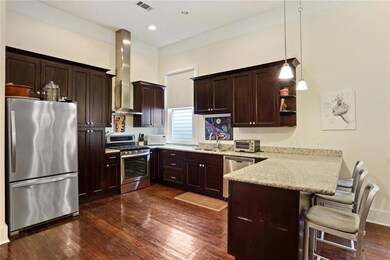 Large kitchen features granite, stainless steel an