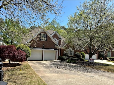 Traditional home featuring brick siding, an attach