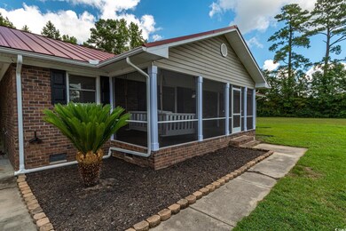 View of property exterior with a yard and a sunroo