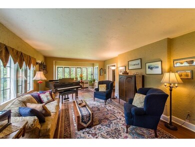 Formal living room with hardwood floors off of the