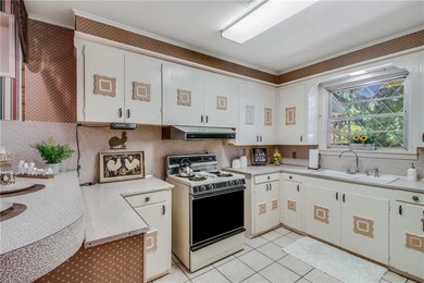 large kitchen with breakfast bar is open to hearth
