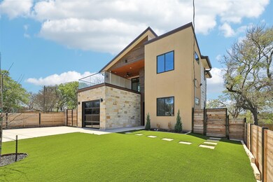 Rear view of house featuring a gate, a ceiling fa