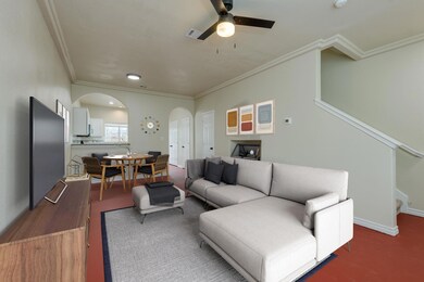 Living room featuring visible vents, arched walkw