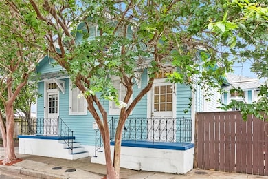 Front of home, gated patio to right