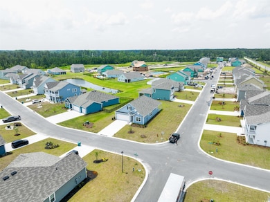Aerial view of residential area featuring a nearby body of water