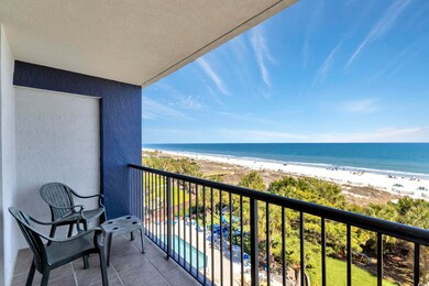 Balcony with a water view and a beach view