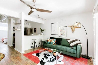 Living area with wood finished floors and a ceili