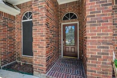 Covered front entry has a beautiful front door wit