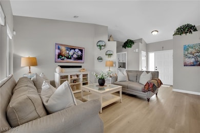 Living room featuring light wood-style flooring, b