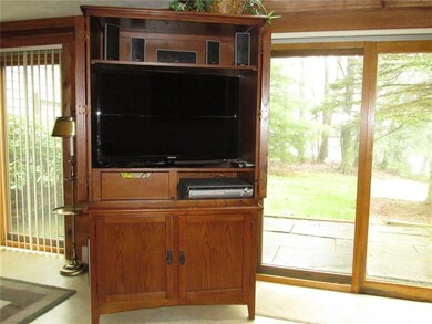 The entertainment center and the flat panel TV are