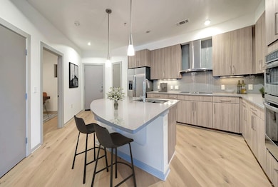 Kitchen with a sink, stainless steel refrigerator