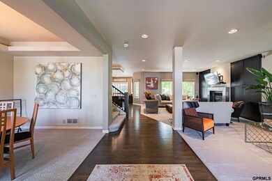 Welcome to your new home.  As you enter the main level you will see an expansive, welcoming space featuring newly refinished hardwood floors, new carpet and views of the pool and boulder wall.