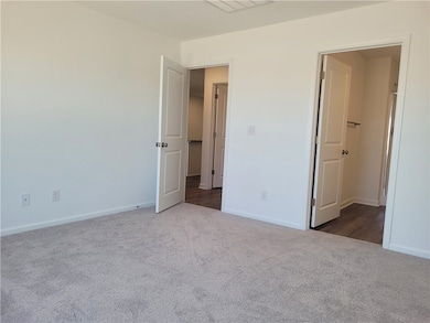 Unfurnished bedroom featuring carpet floors and ba