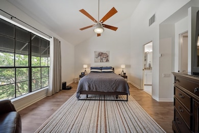 Spacious primary suite with high ceilings, abundan