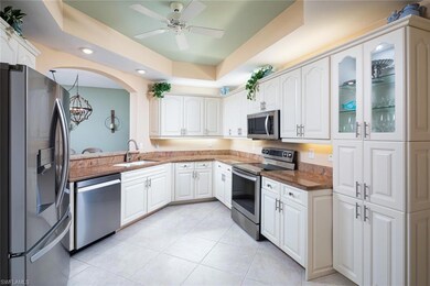 Kitchen with white cabinetry, light tile patterned