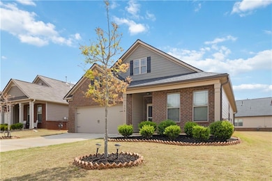 View of front of home with a front yard, brick sid