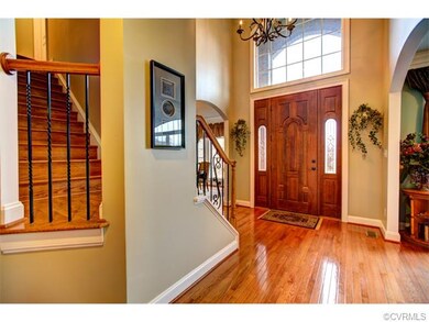 Two-story Foyer with arched openings into Living a