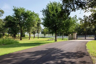 View of community with a gate, fence, and a yard