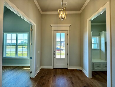 Foyer with office to left and garage entry to righ