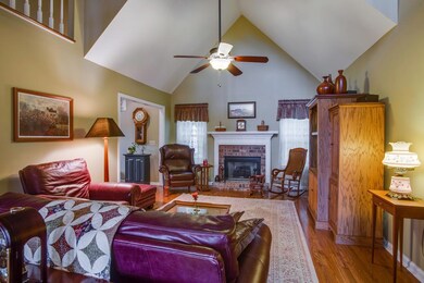 Great room has fireplace and vaulted ceiling.