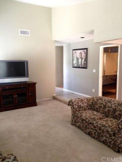 Living Room with vaulted ceilings. Door on the rig
