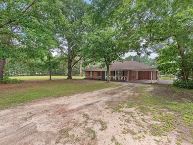 This is a single-story, brick-faced house featurin